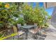 Private patio with table and chairs, nestled amongst lush landscaping at 701 Armada S Rd, Venice, FL 34285