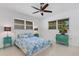 Bedroom with a full bed, teal accents, and built-in closet at 701 Armada S Rd, Venice, FL 34285