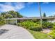 House exterior showcasing a curved driveway and green landscaping at 701 Armada S Rd, Venice, FL 34285