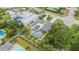Aerial view of house with pool, surrounded by lush landscaping and other homes at 701 Armada S Rd, Venice, FL 34285