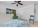 Bedroom with a full bed, teal dresser, and ceiling fan at 701 Armada S Rd, Venice, FL 34285