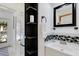 Small bathroom with white vanity, mosaic tile, and shelving at 701 Armada S Rd, Venice, FL 34285