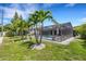 Landscaped backyard with lush tropical plants, palm trees and a pool at 701 Armada S Rd, Venice, FL 34285