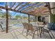 Outdoor patio with dining table, chairs, and pergola covering at 701 Armada S Rd, Venice, FL 34285