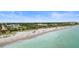 Aerial view of beach community with clear water and sandy beach at 701 Armada S Rd, Venice, FL 34285