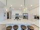 Island kitchen with white cabinets, granite countertops and modern lighting at 379 Aruba Cir # 202, Bradenton, FL 34209