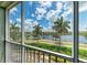 Peaceful screened balcony overlooking the lake and palm trees at 379 Aruba Cir # 202, Bradenton, FL 34209