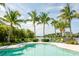 Community pool with lounge chairs and tropical landscaping at 379 Aruba Cir # 202, Bradenton, FL 34209