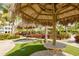 Enjoy the shade under thatched-roof palapas with wood picnic tables at 379 Aruba Cir # 202, Bradenton, FL 34209