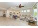 Open living room with kitchen, featuring modern appliances and a large sectional sofa at 379 Aruba Cir # 202, Bradenton, FL 34209