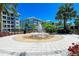 Circular water fountain with compass design in a landscaped courtyard at 379 Aruba Cir # 202, Bradenton, FL 34209