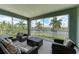 Spacious screened balcony with wicker furniture and lake views at 379 Aruba Cir # 202, Bradenton, FL 34209
