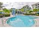 Relaxing community pool with plenty of lounge chairs and umbrellas at 379 Aruba Cir # 202, Bradenton, FL 34209