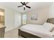 Bedroom with a queen bed, ceiling fan, and access to the bathroom at 379 Aruba Cir # 202, Bradenton, FL 34209