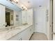 Double vanity bathroom with granite countertops and a large mirror at 379 Aruba Cir # 202, Bradenton, FL 34209