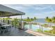 Covered patio with tables and chairs and a water view at 379 Aruba Cir # 202, Bradenton, FL 34209