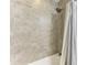 Shower stall with gray tile and a striped shower curtain at 379 Aruba Cir # 202, Bradenton, FL 34209