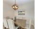 Elegant dining room with wood table and globe chandelier at 379 Aruba Cir # 202, Bradenton, FL 34209