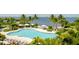 Inviting pool with surrounding lounge chairs and lush landscaping at 379 Aruba Cir # 202, Bradenton, FL 34209
