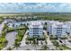Aerial view of waterfront community featuring a lake and parking at 379 Aruba Cir # 202, Bradenton, FL 34209