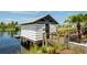 Private boat storage with dock access; steps lead down to water at 379 Aruba Cir # 202, Bradenton, FL 34209