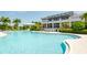 Resort-style pool with lounge chairs and a clubhouse in the background at 379 Aruba Cir # 202, Bradenton, FL 34209