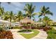 Relaxing shaded seating area with thatch umbrellas and picnic tables at 379 Aruba Cir # 202, Bradenton, FL 34209