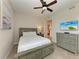 Bedroom with queen bed, dresser, and ceiling fan at 379 Aruba Cir # 202, Bradenton, FL 34209
