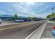 Residential street lined with shops and parking, showing a vibrant, walkable community at 6800 Placida Rd # 281, Englewood, FL 34224