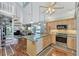 Modern kitchen with light wood cabinets, stainless steel appliances and an island at 6800 Placida Rd # 281, Englewood, FL 34224