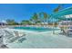 Community swimming pool with lounge chairs and covered seating at 6800 Placida Rd # 281, Englewood, FL 34224