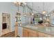 Kitchen with island, stainless steel appliances, and view to living area and bathroom at 6800 Placida Rd # 281, Englewood, FL 34224