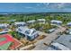 Aerial view showcasing the community's tennis courts and pond at 6800 Placida Rd # 281, Englewood, FL 34224