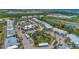 Wide aerial view of community with lush landscaping and pond at 6800 Placida Rd # 281, Englewood, FL 34224