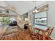 Bright dining area with glass-top table and chairs, adjacent to living room at 6800 Placida Rd # 281, Englewood, FL 34224