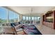 Spacious living room with large windows, comfortable seating, and stunning views at 409 N Point Rd # 501, Osprey, FL 34229