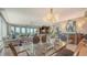 Bright dining room featuring a glass table and elegant chairs, with views to living room at 409 N Point Rd # 501, Osprey, FL 34229