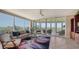 Spacious living room with large windows, comfortable seating, and stunning views at 409 N Point Rd # 501, Osprey, FL 34229