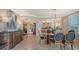 Bright dining room featuring a glass table and elegant chairs, with views to living room at 409 N Point Rd # 501, Osprey, FL 34229