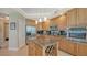 Island kitchen with granite countertops, stainless steel appliances, and wood cabinets at 409 N Point Rd # 501, Osprey, FL 34229