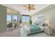 Relaxing bedroom with a comfortable bed, ample natural light, and balcony access at 409 N Point Rd # 501, Osprey, FL 34229