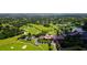 Aerial view showing the community, golf course, and clubhouse at 409 N Point Rd # 501, Osprey, FL 34229