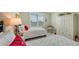 Guest bedroom with twin beds, plantation shutters, and built-in storage at 409 N Point Rd # 501, Osprey, FL 34229