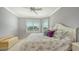 Main bedroom with a ceiling fan, large windows, and a relaxing atmosphere at 409 N Point Rd # 501, Osprey, FL 34229