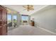 Spacious bedroom with large windows, balcony access, and carpeted floor at 409 N Point Rd # 501, Osprey, FL 34229