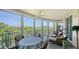 Spacious screened balcony with outdoor seating and scenic nature views at 409 N Point Rd # 501, Osprey, FL 34229
