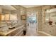 Elegant entryway with decorative wallpaper, mirrored walls, and a tasteful console table at 409 N Point Rd # 501, Osprey, FL 34229