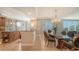 Elegant dining area with a glass-top table and comfortable seating for six at 409 N Point Rd # 501, Osprey, FL 34229