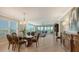 Bright dining room featuring a glass table and elegant chairs, with views to living room at 409 N Point Rd # 501, Osprey, FL 34229
