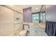 Clean bathroom with a shower, toilet, and vanity with a granite countertop at 409 N Point Rd # 501, Osprey, FL 34229